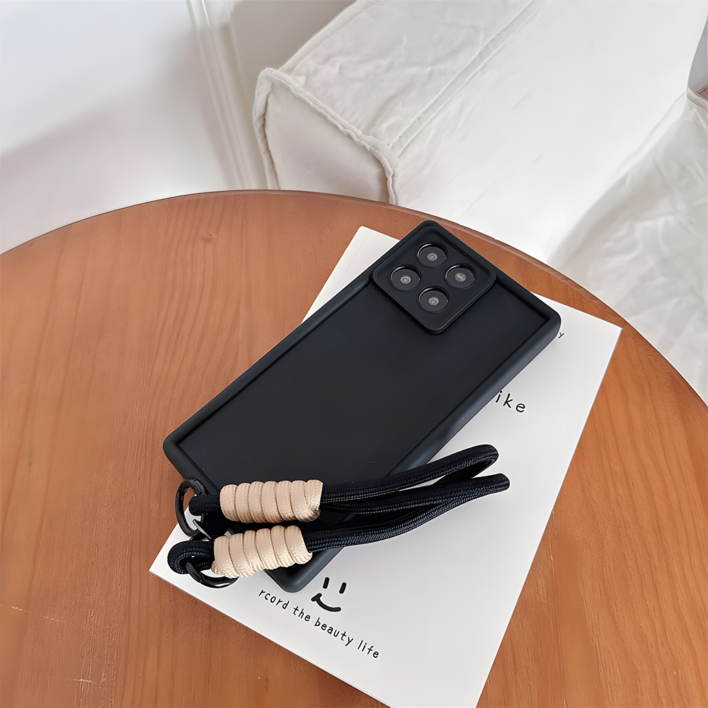 Black phone case with a lanyard on a wooden table